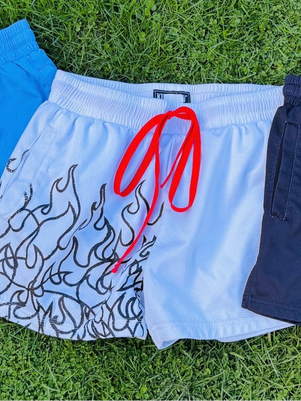 Kill Crew White Athletic Shorts with Red Drawstring and Black Flame Graphics